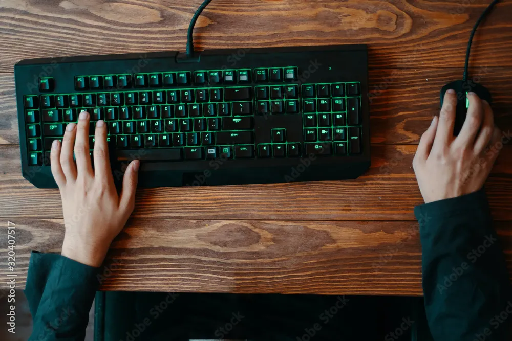 a top down view of a right handed person using keyboard and mouse